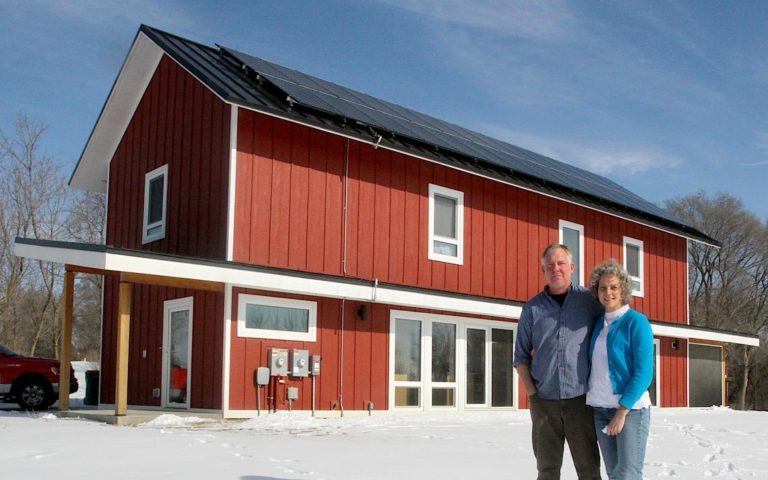 Matt and Tracee Vetting stand in front of their net-zero energy passive house built in Rochester, Minnesota